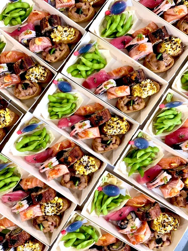 Rows of catering sushi boxes ready for pickup